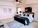 Bedroom with neutral walls, a black bed frame, tray ceiling, and decor paintings at 2750 Brentwood Estates Ct, Cumming, GA 30041