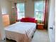Bedroom with two large windows dressed with red and white curtains at 2750 Brentwood Estates Ct, Cumming, GA 30041