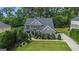 Beautiful two-story brick home with a well-manicured lawn and mature trees at 2750 Brentwood Estates Ct, Cumming, GA 30041