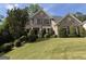 Charming brick home featuring a well-maintained lawn and beautiful landscaping for great curb appeal at 2750 Brentwood Estates Ct, Cumming, GA 30041