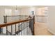 Upstairs hallway with wooden railings, natural light, and access to multiple rooms at 2750 Brentwood Estates Ct, Cumming, GA 30041