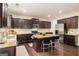 Eat-in kitchen featuring dark wood cabinets, granite countertops, and stainless steel appliances at 2750 Brentwood Estates Ct, Cumming, GA 30041