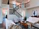 Beautiful living room with high ceilings, modern staircase, and sophisticated decor at 2750 Brentwood Estates Ct, Cumming, GA 30041