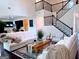 Bright living room features staircase, modern seating, wood floors, and natural light; adjacent kitchen visible at 2750 Brentwood Estates Ct, Cumming, GA 30041