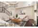 Spacious living room featuring a staircase, fireplace, stylish furniture and dark wood floors at 2750 Brentwood Estates Ct, Cumming, GA 30041