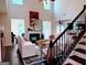 Bright living room featuring high ceilings, fireplace, staircase, and plenty of natural light at 2750 Brentwood Estates Ct, Cumming, GA 30041