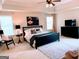 Spacious main bedroom boasts a ceiling fan, natural light and a seating area at 2750 Brentwood Estates Ct, Cumming, GA 30041