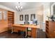 Spacious office featuring custom wooden built-in shelves, a large desk, and natural light at 2750 Brentwood Estates Ct, Cumming, GA 30041