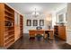 Spacious office featuring custom wooden built-in shelves, a large desk, and natural light at 2750 Brentwood Estates Ct, Cumming, GA 30041