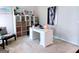 Home office with a white desk, cube storage with baskets, and a cozy accent chair at 2750 Brentwood Estates Ct, Cumming, GA 30041