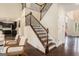 Elegant staircase with hardwood treads, wrought iron spindles, and ample natural light at 2750 Brentwood Estates Ct, Cumming, GA 30041