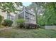 Multi-level deck overlooking the backyard, with a covered area and steps leading down to the yard at 102 Passage Point, Peachtree City, GA 30269