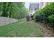 Backyard featuring a privacy fence and mature trees, creating a private and peaceful outdoor space at 102 Passage Point, Peachtree City, GA 30269