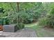 Brick patio area with an outdoor storage box, leading to a serene backyard at 102 Passage Point, Peachtree City, GA 30269