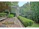 Landscaped backyard with a vegetable garden, a wooden bench and tiered planting areas at 102 Passage Point, Peachtree City, GA 30269