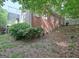 Brick and stucco home with a deck overlooking a leafy backyard on an embankment at 102 Passage Point, Peachtree City, GA 30269