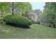 Spacious backyard featuring a lush lawn, mature trees, and beautiful landscaping at 102 Passage Point, Peachtree City, GA 30269