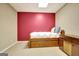 Finished basement with a daybed, vintage furniture, and red accent wall at 102 Passage Point, Peachtree City, GA 30269