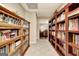 Basement hallway featuring floor to ceiling custom-built wooden shelving at 102 Passage Point, Peachtree City, GA 30269