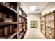 Basement hallway showcasing beautiful wooden bookshelves filled with books at 102 Passage Point, Peachtree City, GA 30269