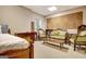 Basement rec area with a sofa and chairs, decorated with a guitar and vintage furniture at 102 Passage Point, Peachtree City, GA 30269