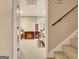 Stairwell leading to a basement with neutral carpet and wood railing at 102 Passage Point, Peachtree City, GA 30269