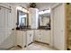 Bathroom featuring double sinks, granite countertops, and custom cabinetry at 102 Passage Point, Peachtree City, GA 30269