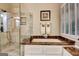 Relaxing bathroom featuring a separate tub and shower, with refined marble accents at 102 Passage Point, Peachtree City, GA 30269