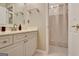 Bathroom featuring a white vanity with a framed mirror and tiled floors with shower at 102 Passage Point, Peachtree City, GA 30269