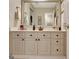 Bright bathroom vanity featuring traditional cabinetry, a framed mirror and a neutral countertop at 102 Passage Point, Peachtree City, GA 30269