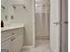 Cozy bathroom with a white vanity, framed mirror and tiled floors near the bathtub at 102 Passage Point, Peachtree City, GA 30269