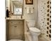 Cozy bathroom with pedestal sink, framed mirror, and patterned shower curtain at 102 Passage Point, Peachtree City, GA 30269