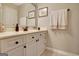 Bright bathroom features a vanity with white cabinetry, dark hardware, and neutral countertops at 102 Passage Point, Peachtree City, GA 30269