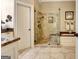A stunning bathroom with a glass enclosed tiled shower and elegant marble countertops at 102 Passage Point, Peachtree City, GA 30269