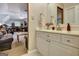 Bathroom featuring a white vanity with a bright mirror and light, neutral walls at 102 Passage Point, Peachtree City, GA 30269