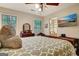 This bedroom features a television, dresser, ceiling fan, and a bed at 102 Passage Point, Peachtree City, GA 30269