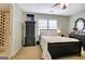 Cozy bedroom features a black dresser, soft lighting, and view into the adjoining bathroom at 102 Passage Point, Peachtree City, GA 30269