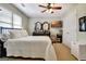 Comfortable bedroom features soft lighting, white bedding and decorative accents for a peaceful space at 102 Passage Point, Peachtree City, GA 30269