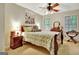 Bedroom with a large bed, neutral walls, a ceiling fan, and two windows at 102 Passage Point, Peachtree City, GA 30269