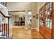 Warm foyer showcasing hardwood floors, staircase detail, and a dining area at 102 Passage Point, Peachtree City, GA 30269
