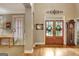 Open foyer with hardwood floors, transom window, and a view into the dining and living areas at 102 Passage Point, Peachtree City, GA 30269