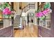 Elegant foyer with hardwood floors, staircase, and decorative floral wreaths on the entryway doors at 102 Passage Point, Peachtree City, GA 30269