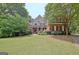 Charming two-story brick home with a manicured lawn, lovely garden, and inviting entrance at 102 Passage Point, Peachtree City, GA 30269