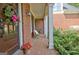Charming front porch with brick flooring, white columns, and inviting decor at 102 Passage Point, Peachtree City, GA 30269