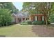Charming two-story brick home with a manicured lawn and a welcoming front porch at 102 Passage Point, Peachtree City, GA 30269