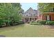 Beautiful two-story home with a manicured lawn and professionally landscaped garden at 102 Passage Point, Peachtree City, GA 30269