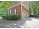 Spacious three-car garage with white doors and a large driveway at 102 Passage Point, Peachtree City, GA 30269