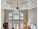 Great room with high ceilings, a ceiling fan, and many windows at 102 Passage Point, Peachtree City, GA 30269