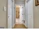 Hallway view of a bathroom featuring an open door that showcases the tiled shower at 102 Passage Point, Peachtree City, GA 30269
