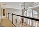 Upstairs hallway overlooking the main floor, with detailed ceilings and large windows at 102 Passage Point, Peachtree City, GA 30269
